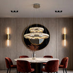 Gold Crystal Chandelier with Brass Wall Sconces and Recessed LED Lights