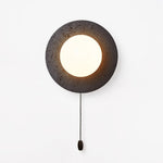 Crater Backlit Wall Sconce in Black Travertine with Opal Glass Globe