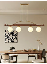 Adorned Linear Chandelier in Walnut and Brass with Glass Orbs
