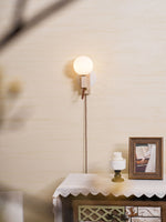 Atlas Globe Wall Sconce in Travertine and Opal Glass