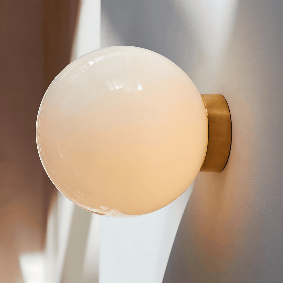 Aura Globe Glass Wall Sconce in Brass for Modern Interiors