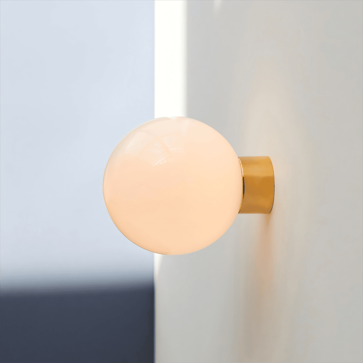 Aura Globe Glass Wall Sconce in Brass for Modern Interiors