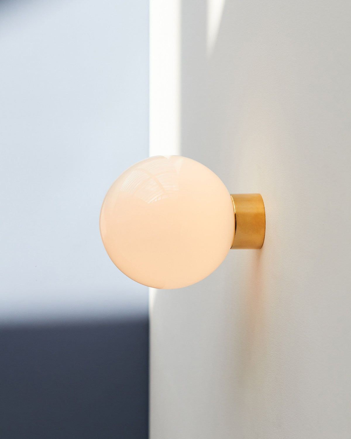 Aura Globe Glass Wall Sconce in Brass for Modern Interiors