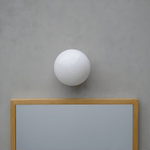 Aura Globe Glass Wall Sconce in Brass for Modern Interiors