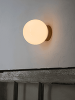 Aura Globe Glass Wall Sconce in Brass for Modern Interiors
