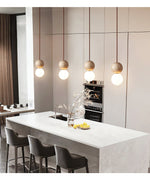 Camille Travertine Pendant Light – Natural Stone Sphere with Opal Glass Globe