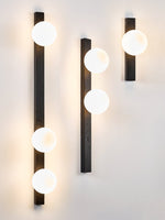 Balanced Globe Wall Sconce in Black Travertine and Opal Glass