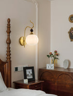 Celeste Curved Wall Sconce in Gold or Black with Pleated Glass Shade