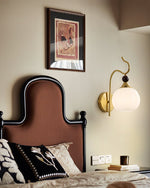 Celeste Curved Wall Sconce in Gold or Black with Pleated Glass Shade