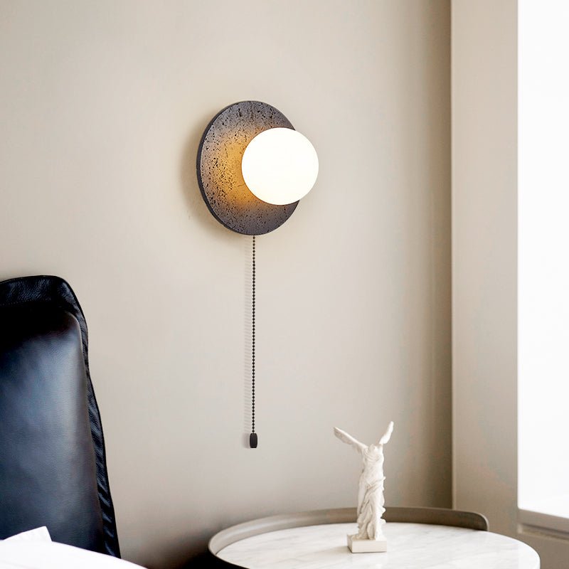Crater Backlit Wall Sconce in Black Travertine with Opal Glass Globe