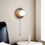 Crater Backlit Wall Sconce in Black Travertine with Opal Glass Globe