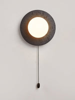 Crater Backlit Wall Sconce in Black Travertine with Opal Glass Globe