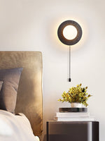 Crater Backlit Wall Sconce in Black Travertine with Opal Glass Globe