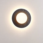 Crater Backlit Wall Sconce in Black Travertine with Opal Glass Globe