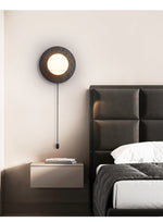 Crater Backlit Wall Sconce in Black Travertine with Opal Glass Globe