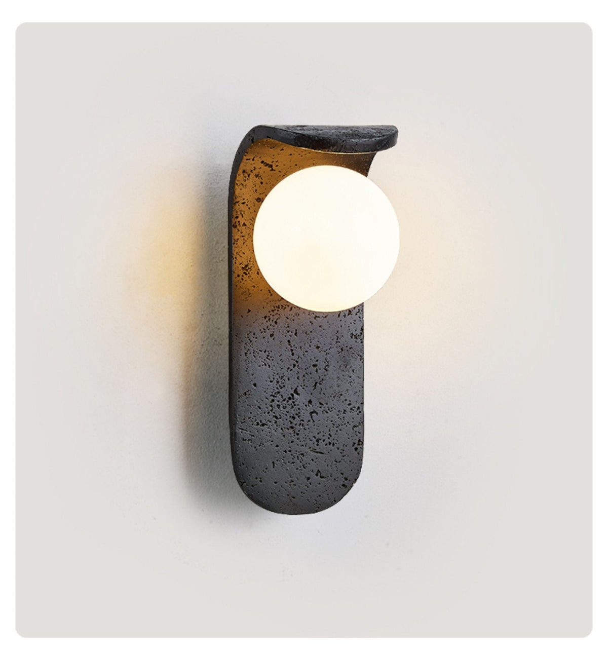 Eclipse Orb Wall Sconce in Black Travertine with Opal Glass Shade