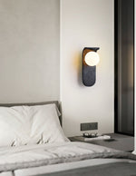 Eclipse Orb Wall Sconce in Black Travertine with Opal Glass Shade