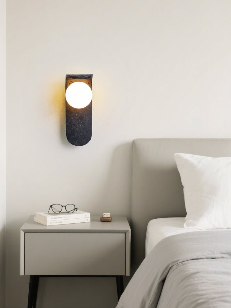 Eclipse Orb Wall Sconce in Black Travertine with Opal Glass Shade