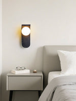 Eclipse Orb Wall Sconce in Black Travertine with Opal Glass Shade