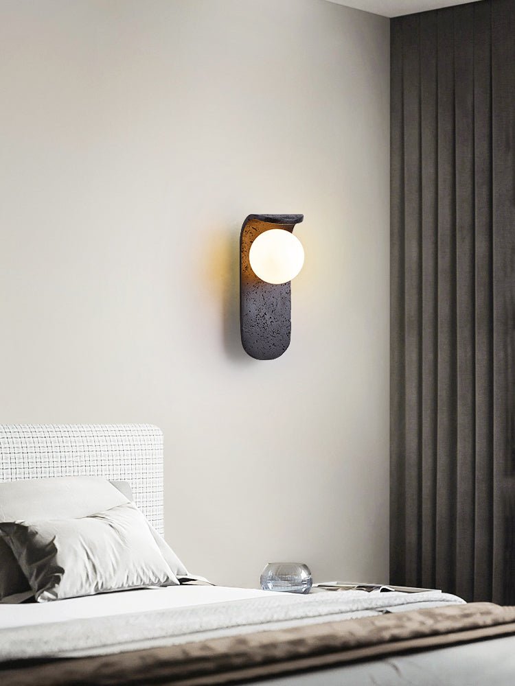 Eclipse Orb Wall Sconce in Black Travertine with Opal Glass Shade