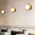 Elira Wall Sconce in Yellow Travertine with Opal Glass Shade
