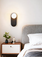 Eventide Orb Wall Sconce in Black Travertine with Opal Glass Globe