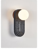Eventide Orb Wall Sconce in Black Travertine with Opal Glass Globe