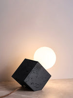 Kryden Sculptural Table Lamp in Black Travertine with Glass Globe