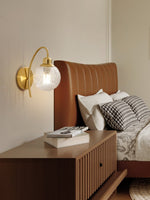 Lucienne Curved Wall Sconce in Gold with Clear Glass Globe