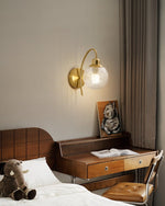 Lucienne Curved Wall Sconce in Gold with Clear Glass Globe