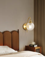 Lucienne Curved Wall Sconce in Gold with Clear Glass Globe
