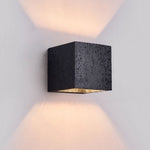 Lumina Void Sconce — Black Travertine Wall Light with Warm Glow
