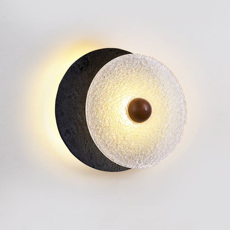 Lunara Textured Disc Wall Sconce in Black Travertine and Frosted Glass