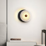 Lunara Textured Disc Wall Sconce in Black Travertine and Frosted Glass