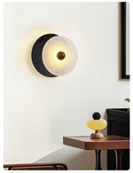 Lunara Textured Disc Wall Sconce in Black Travertine and Frosted Glass