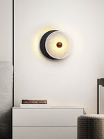 Lunara Textured Disc Wall Sconce in Black Travertine and Frosted Glass