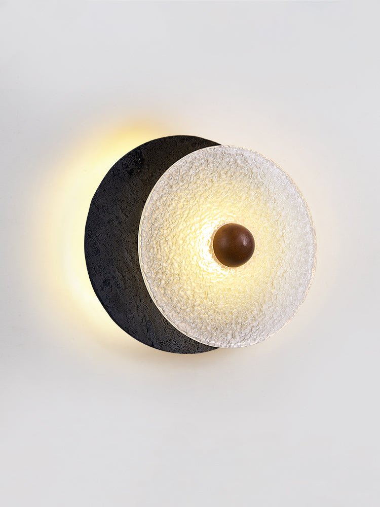Lunara Textured Disc Wall Sconce in Black Travertine and Frosted Glass