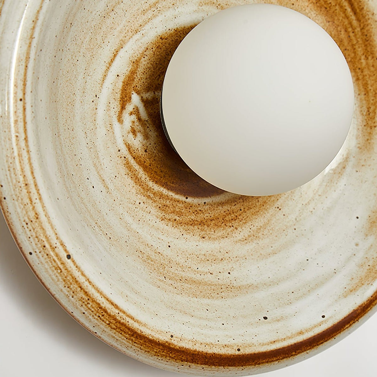 Solstice Swirl Ceramic Wall Sconce with Glowing Orb