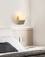 Tavian Orb Travertine Wall Sconce with Glass Globe