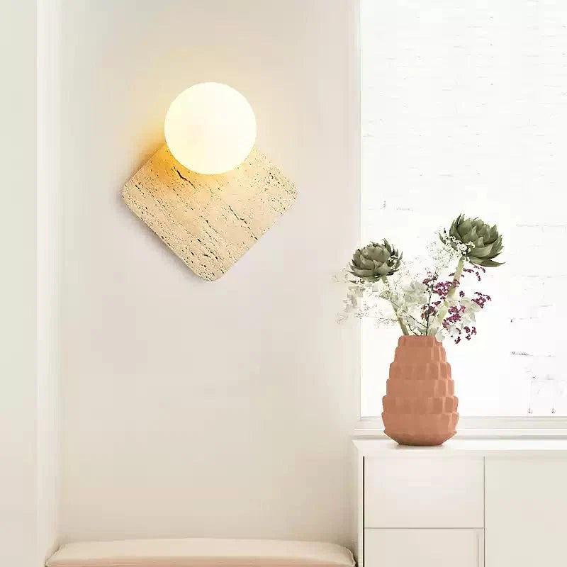 Travora Globe Wall Sconce in Natural Travertine with Opal Glass Shade