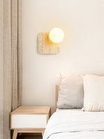 Travora Globe Wall Sconce in Natural Travertine with Opal Glass Shade