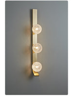 Vertical Balls Bar Wall Sconce in Gold with Clear Glass Globes