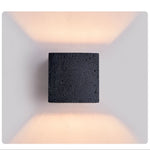 Vulcanis Cube Wall Sconce in Black Travertine with Golden Interior
