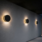 Modern Round Outdoor Wall Sconce in Black Stainless Steel with Warm LED Glow