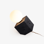 Kryden Sculptural Table Lamp in Black Travertine with Glass Globe