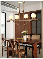 Adorned Linear Chandelier in Walnut and Brass with Glass Orbs