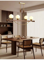 Adorned Linear Chandelier in Walnut and Brass with Glass Orbs