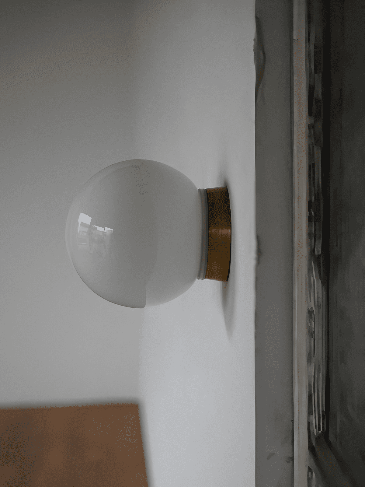 Aura Globe Glass Wall Sconce in Brass for Modern Interiors