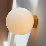 Aura Globe Glass Wall Sconce in Brass for Modern Interiors