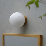 Aura Globe Glass Wall Sconce in Brass for Modern Interiors